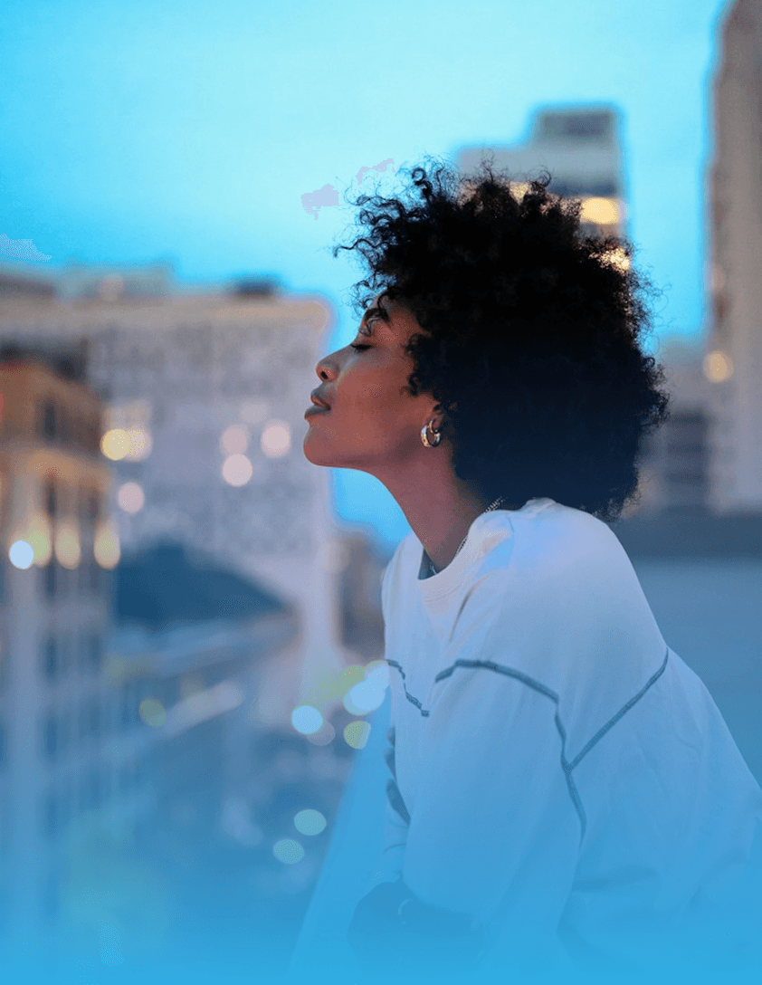 Traveler enjoying sunset city skyline