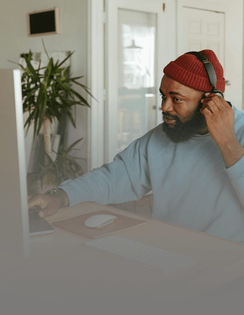 Freelancer working remotely at computer with headset